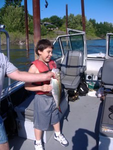 A child holding a Columbia River shad that he caught.