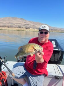 A picture of your Oregon fishing guide, holding a Columbia River Bass. 