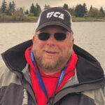 Marvin Henkel - Oregon Fishing Guide, wearing a Tica cap and sunglasses