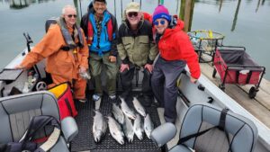 Happy clients with limits all around from a hot morning bite on the Pacific Ocean west of Astoria, aboard the Marvin's Guide Service boat.