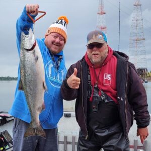 A happy customer holds up a spring chinook salmon caught fishing on the Willamette River with Marvin's Guide Service.